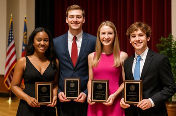 Students in Greek organization apparel at a university recognition ceremony for service and leadership awards.